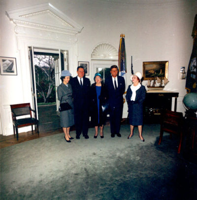 U.S. Congressional Representative from Louisiana Thomas Hale Boggs visiting President John F. Kennedy in the Oval Office along with his wife, Lindy Boggs, and two other unidentified women. White House, Washington D.C., November 5, 1963 [WHP-ST-C380-2-63]
