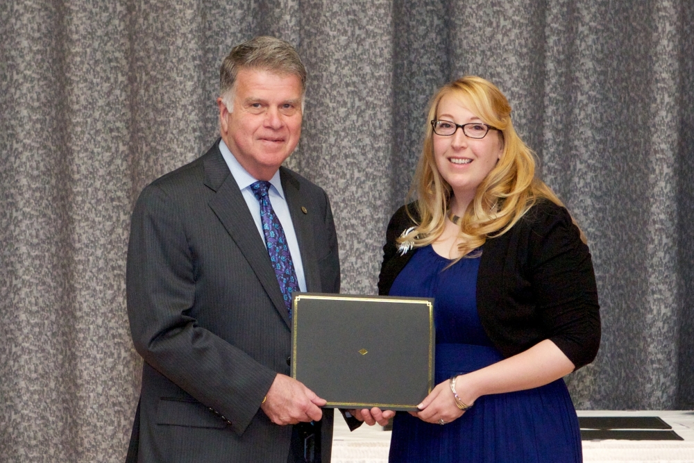 Archivist of the United States David Ferriero presents Kennedy Library volunteer Meghan Testerman with the Weidman Outstanding Volunteer Service Award at Archives II in College Park, MD, 7 May 2014.